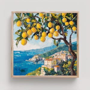 May include: An oil painting on canvas featuring a lemon tree with bright yellow fruit in the foreground, overlooking a coastal village with light-colored buildings and terracotta roofs nestled against a deep blue sea and distant mountains.