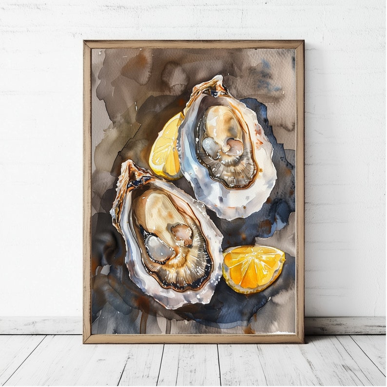 May include: Watercolor painting of two open oysters with bright yellow lemon wedges. The artwork is framed in a light brown wooden frame and set against a dark, textured background. The painting is displayed on a white wooden surface.
