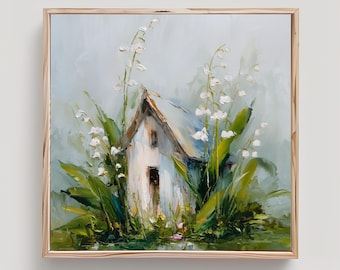 May include: An oil painting in a light wood frame depicting a small white cottage nestled among tall green leaves and delicate white lily of the valley flowers. The artwork features visible brushstrokes and a soft, muted colour palette.