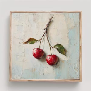 May include: A square oil painting on canvas featuring two bright red cherries hanging from a single brown stem with two green leaves. The background is a textured, impasto-style application of pale blue and off-white paint in a wooden frame.