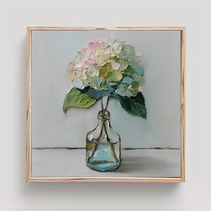 May include: An oil painting in a light wood frame depicting a hydrangea flower with thick, textured brushstrokes in shades of pink, white, and green. The flower sits in a clear glass bottle with visible stems, set against a neutral background.