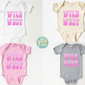 May include: Four baby onesies in different colors with the text "WILD like the WEST" in pink letters. The onesies are white, beige, pink, and gray.