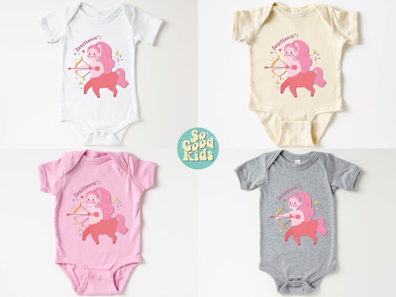 May include: Four baby onesies in different colours, white, beige, pink, and grey, with a pink cartoon Sagittarius zodiac sign with an arrow and the text "Sagittarius" on each onesie.