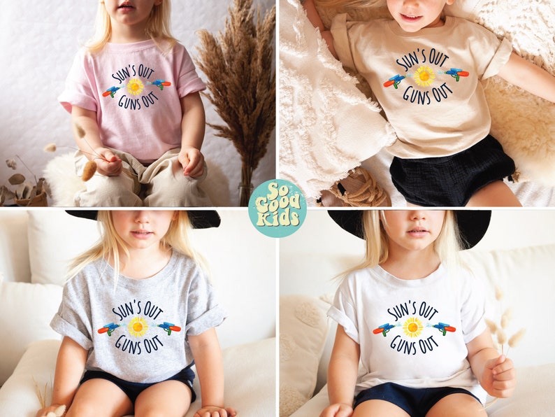 May include: A collection of children's t-shirts in various colors, each featuring the phrase "SUN'S OUT GUNS OUT" with a sun and water gun graphic. The shirts are light pink, beige, gray, and white.