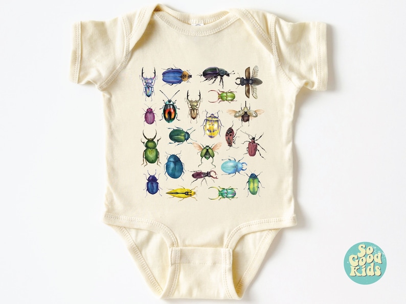 May include: A cream-coloured baby onesie with a colourful pattern of various beetles. The onesie has short sleeves and a snap closure. The text "So Good Kids" is printed on a blue circle in the bottom right corner.