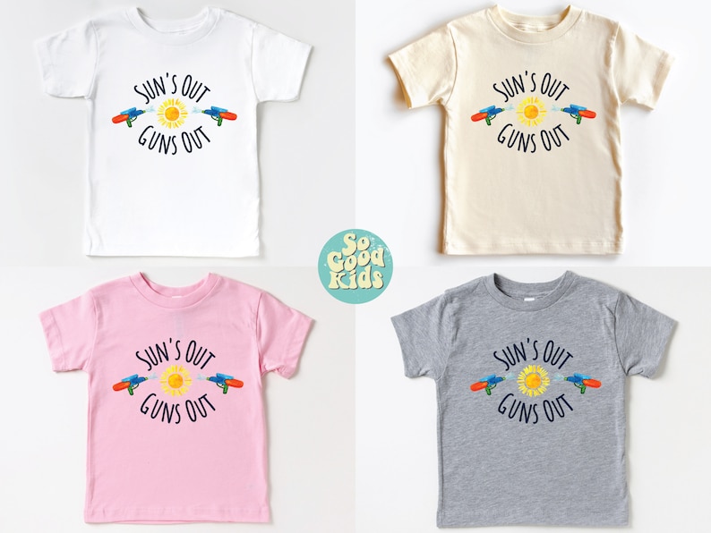 May include: Four children's t-shirts in white, beige, pink, and gray, each featuring the text "SUN'S OUT GUNS OUT" with a sun and water guns graphic. The shirts are short-sleeved.