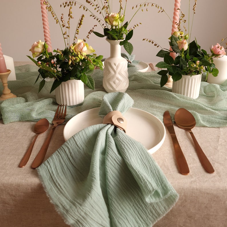 Muslin napkins and sage napkins are the perfect choice for wedding tables, offering a blend of soft texture and understated luxury that elevates any setting.