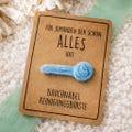 Belly button cleaning brush – Funny gift for someone who has everything – Kraft paper card for a colleague, friend, or boss – Funny little something product logo