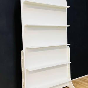 A beautifully designed arched party backdrop featuring built-in shelves, perfect for showcasing decorations, party favors, or other items at events and gatherings. Ideal for creating a stylish and functional display at any celebration.