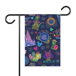 May include: A navy blue garden flag featuring a colorful, whimsical design. The flag showcases illustrations of a dragon, castle, and other parade elements. The words "Main Street Electrical Parade" and "Parade" are also visible.