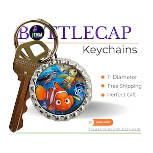 May include: A silver bottle cap keychain with a colorful image of Finding Nemo characters, including Nemo, Dory, and a turtle. The keychain is attached to a gold key ring.