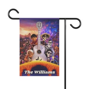 May include: A garden flag featuring a colorful illustration from the movie Coco, with the text "The Williams" at the bottom. The design includes a guitar and several animated characters against a vibrant city backdrop.