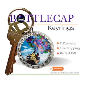May include: A keychain featuring a 1-inch diameter bottle cap with a colorful image of a house flying with balloons. The keychain is attached to a silver key ring.