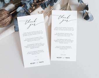 May include: Two white thank you cards with black calligraphy text. The text reads "Thank you" and includes a message thanking guests for sharing in the joy of the wedding day. The cards are signed "Kelsey & Travis".