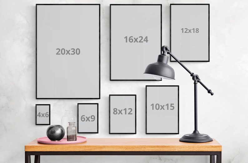 May include: A collection of black picture frames of various sizes hanging on a white wall. The frames are empty and have the dimensions 4x6, 6x9, 8x12, 10x15, 12x18, 16x24, and 20x30 inches.