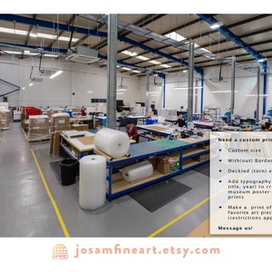 May include: A large warehouse with several people working on tables. The tables are filled with rolls of bubble wrap and boxes. The text on the wall reads "Need a custom print? Custom size, With(out) Borders, Deckled (torn) edges, Add typography (artist title, year) to create museum poster-style prints, Make a print of your favorite art piece (restrictions apply), Message us! josamfineart.etsy.com"