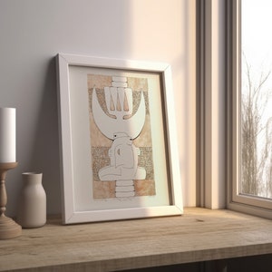 May include: A white framed print of a black and white abstract drawing with a brown background. The drawing features a stylized figure with a crown and a crescent moon.