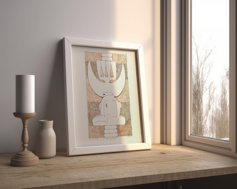 May include: A white framed print of a black and white abstract drawing with a brown background. The drawing features a stylized figure with a crown and a crescent moon.