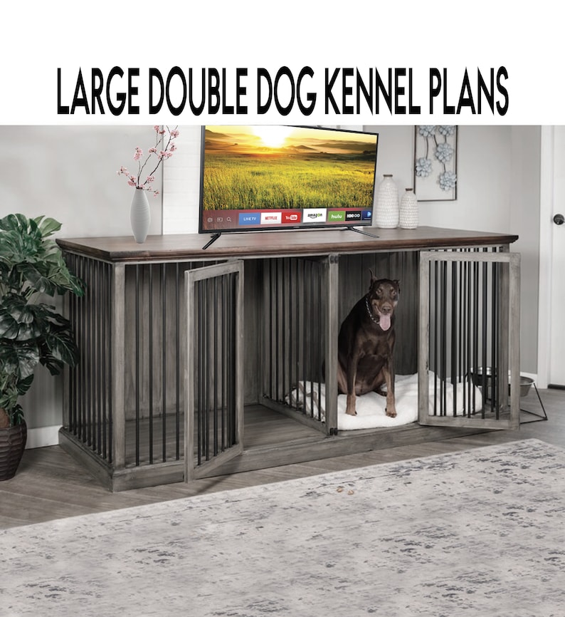 May include: A large double dog kennel with a gray wood finish and black metal bars. The kennel has two doors and is sitting on a wooden floor. A brown dog is sitting inside one of the kennels.
