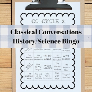 May include: A clipboard with a printed bingo game titled "Classical Conversations History/Science Bingo." The game board features historical topics like the French Revolution and the Korean War. The clipboard has a silver clip and is on a wooden surface.