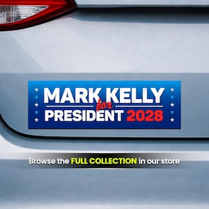 May include: A blue bumper sticker with white text that reads "MARK KELLY for PRESIDENT 2028." The text is surrounded by small white stars. The bumper sticker is affixed to the back of a vehicle.