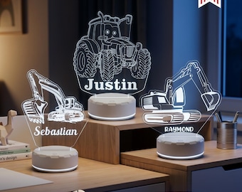 May include: Three custom acrylic LED night lights featuring engraved construction vehicle designs, including a tractor labeled Justin, and two excavators labeled Sebastian and Raymond. Each light sits on a round white base with 16 light colors.