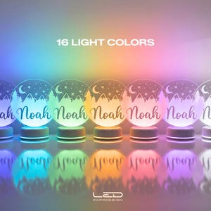 May include: Seven illuminated LED night lights with the name "Noah" in a script font. Each light has a circular design with a mountain and tree scene, a crescent moon, and stars. The text "16 LIGHT COLORS" is at the top.