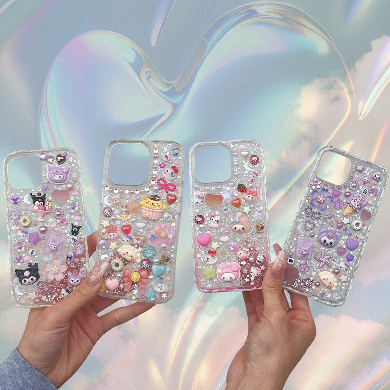 May include: Four clear phone cases decorated with colorful cartoon characters, glitter, and rhinestones. The cases are designed in a kawaii style.