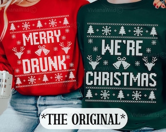 May include: A matching set of two Christmas sweaters. One sweater is red with the text "Merry Drunk" and the other is forest green with the text "We're Christmas". Both sweaters feature a white snowflake and Christmas tree pattern.