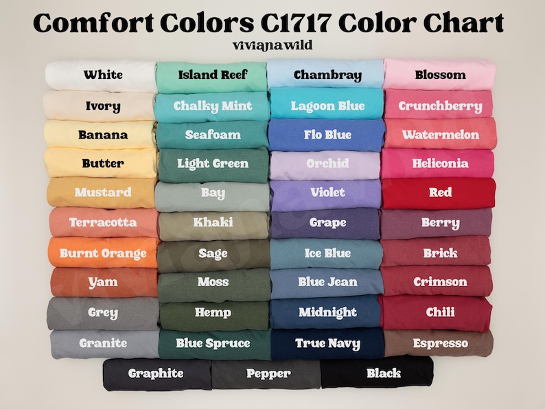 May include: Color chart displaying Comfort Colors C1717 colors. The chart features a variety of colors, including white, ivory, banana, butter, mustard, terracotta, burnt orange, yam, grey, and granite. Each color is labeled with its name.