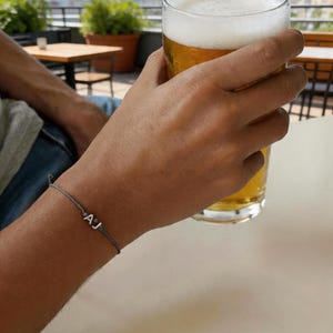 Adjustable string bracelet with letters