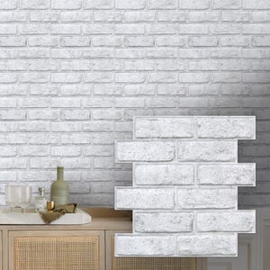 May include: A rectangular wall panel featuring a white brick pattern with a textured, realistic finish. The panel displays a repeating arrangement of individual bricks with visible mortar lines, designed to mimic the appearance of a classic masonry wall.