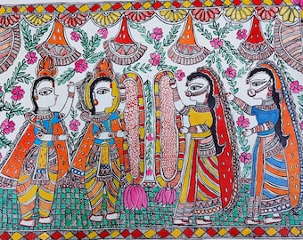 May include: A colorful Madhubani painting on paper featuring four figures in traditional attire, two holding large floral garlands. The scene is framed by a geometric border with red and yellow diamonds, accented by floral vines and hanging decorative motifs.