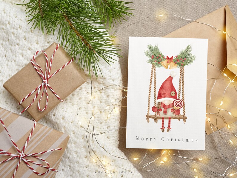 A cute Christmas card featuring a watercolor illustration of gnome, surrounded by festive decorations and winter elements