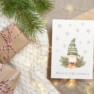 Adorable watercolor Christmas card featuring a whimsical gnome, set against a backdrop of colorful holiday decorations and stars