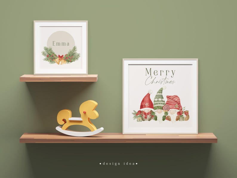 May include: Two framed prints on a wooden shelf. The top print has a green wreath with red berries and gold bells and the text "Emma". The bottom print has the text "Merry Christmas" and a watercolour illustration of three gnomes wearing red and green hats.