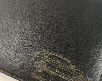 May include: Black leather wallet with an engraved car design and the text "your text here".