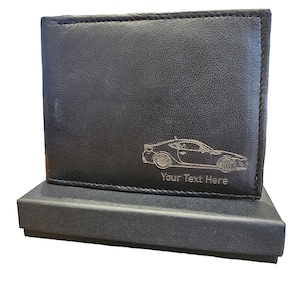 May include: Black leather wallet with a silver embossed car silhouette and the text "Your Text Here". The wallet is in a black gift box.