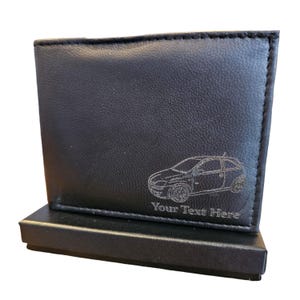 May include: Black leather wallet with a silver-coloured car silhouette and the text "Your Text Here" engraved on the front.
