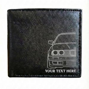 May include: Black leather wallet with a white outline of a car's front. The text "YOUR TEXT HERE" is below the car graphic. The wallet has a textured surface.