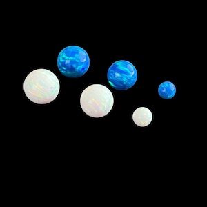 May include: A set of three ceramic mugs with a speckled, matte finish. Each mug features a different color: light blue, cream, and gray. The mugs have a simple, modern design and a comfortable handle.