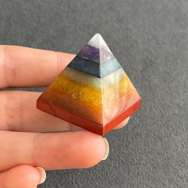 May include: A seven-layered pyramid made of various crystals, including amethyst, clear quartz, citrine, and red jasper. The pyramid is a popular tool for meditation and energy healing.