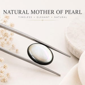 May include: An oval-shaped natural mother of pearl cabochon with a smooth, iridescent surface held by metal tweezers. The text NATURAL MOTHER OF PEARL, TIMELESS • ELEGANT • NATURAL is visible at the top of the image in a dark grey font.