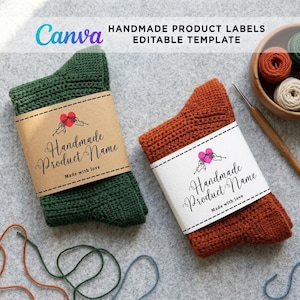A square image featuring a pair of handmade crochet socks on a grey textured background. The left sock is deep green and wrapped in a brown kraft paper label, while the right sock is rust-orange and wrapped in a clean white paper label. A wooden bowl with yarn balls, loose yarn strands, and a crochet hook lie nearby, with a Canva template banner at the top.