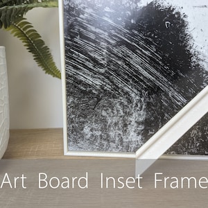 May include: White art board inset frame with a black and white abstract print. The frame is made of wood and has a simple, modern design.
