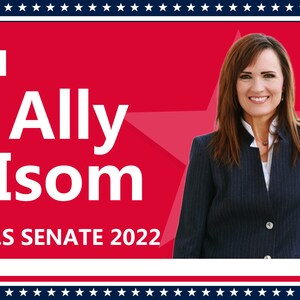 May include: A red, white, and blue campaign poster with a white star in the background. The poster features a woman in a navy blue blazer and the text "Ally Isom U.S. SENATE 2022."