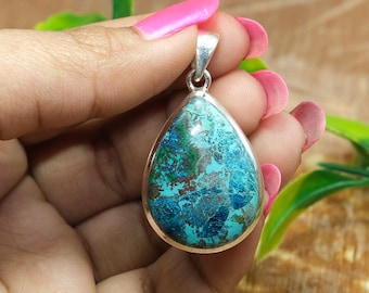 May include: A teardrop-shaped pendant with a blue and green chrysocolla stone set in sterling silver.