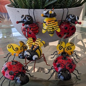 Cute metal bumble bees and ladybugs embellished with rhinestones to add more sparkle to your plant pots,