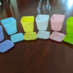 Sets of 6 plastic plant pots with matching saucers. Shipping for each additional set 0.75. Sets has one pot and saucer in each color.