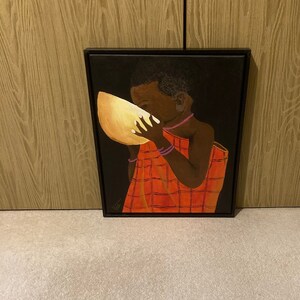 Boy drinking water in a gourd